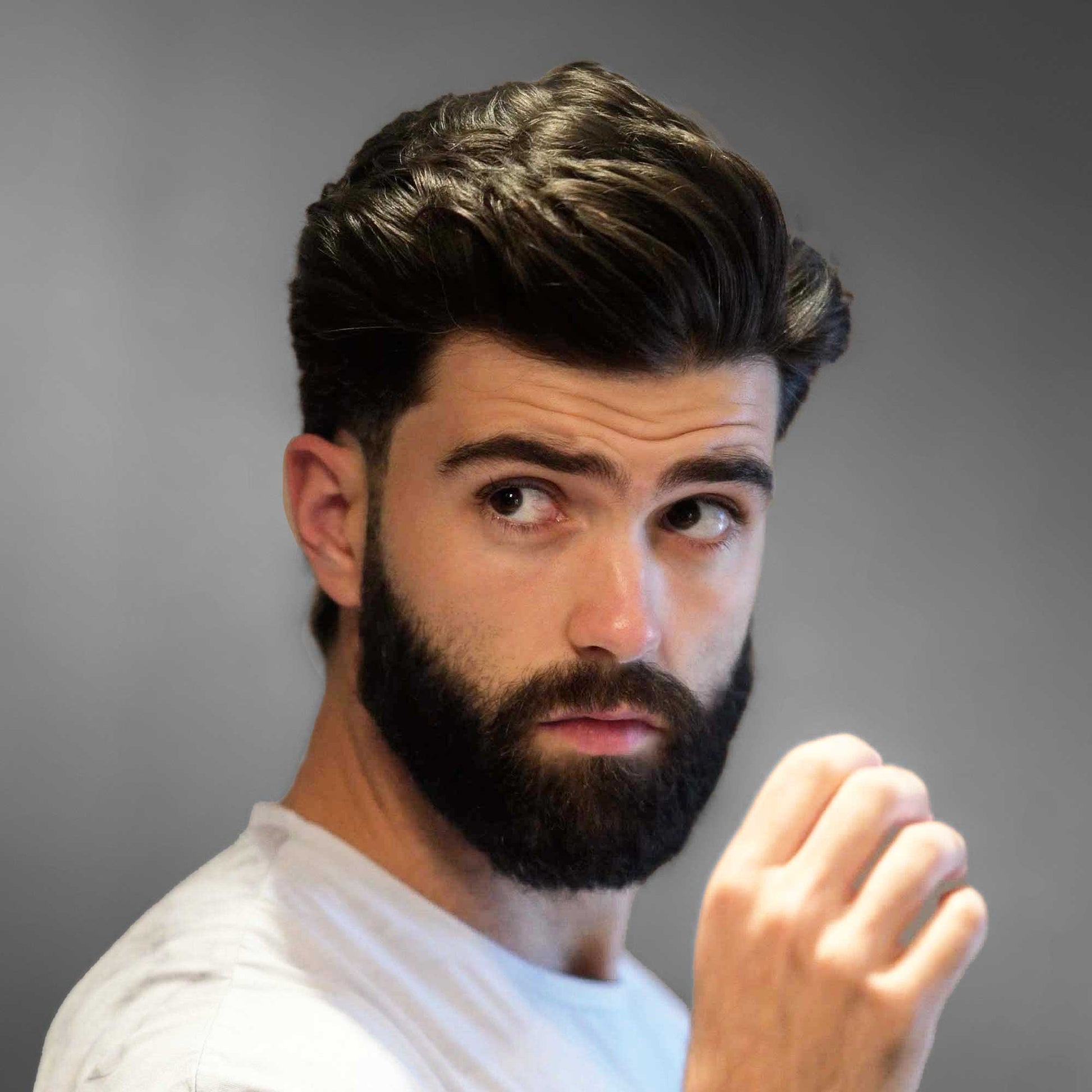 Male model applying BLUMAAN Heavy Hold Clay to style thick hair with strong hold