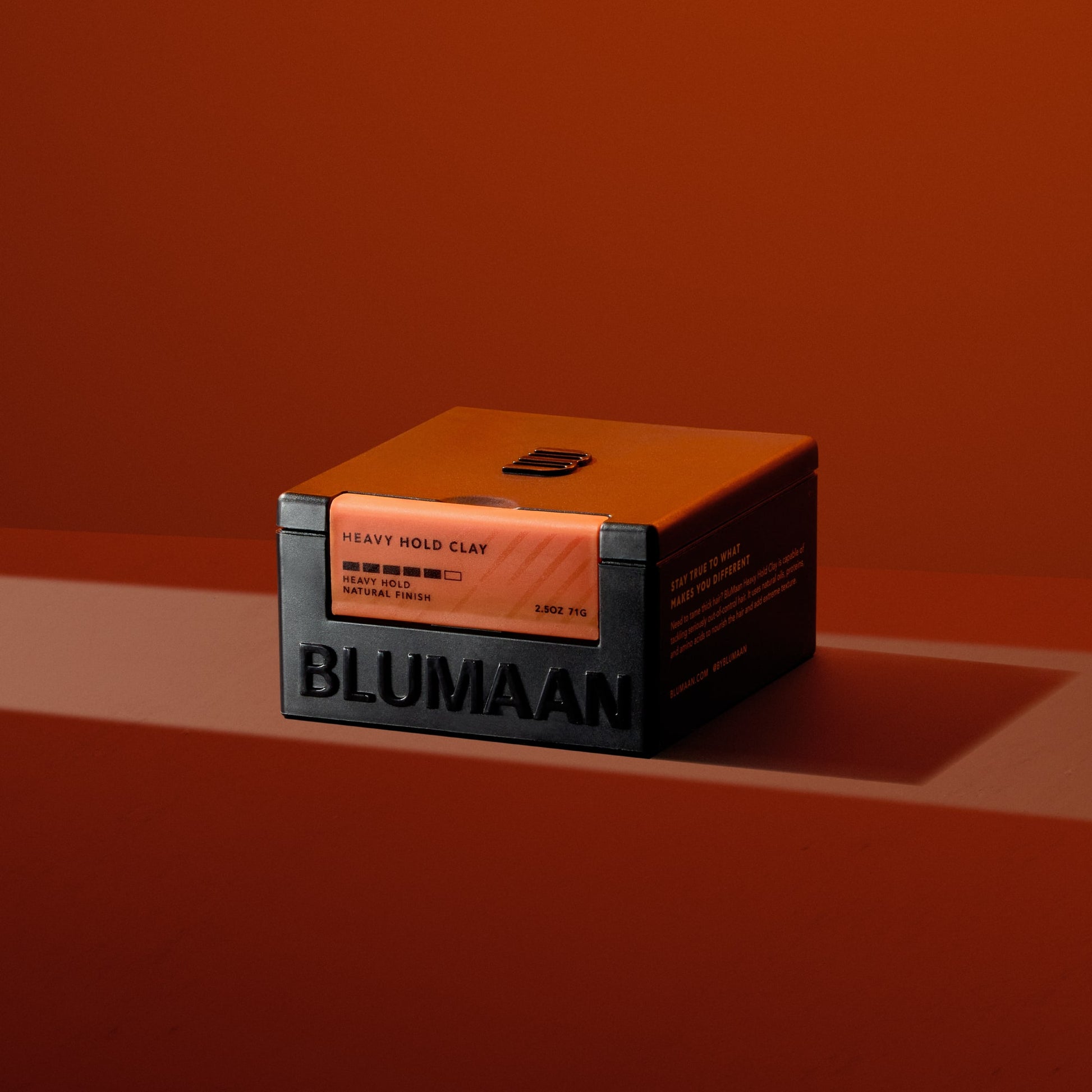 BLUMAAN Heavy Hold Clay new packaging on red background for modern, bold presentation