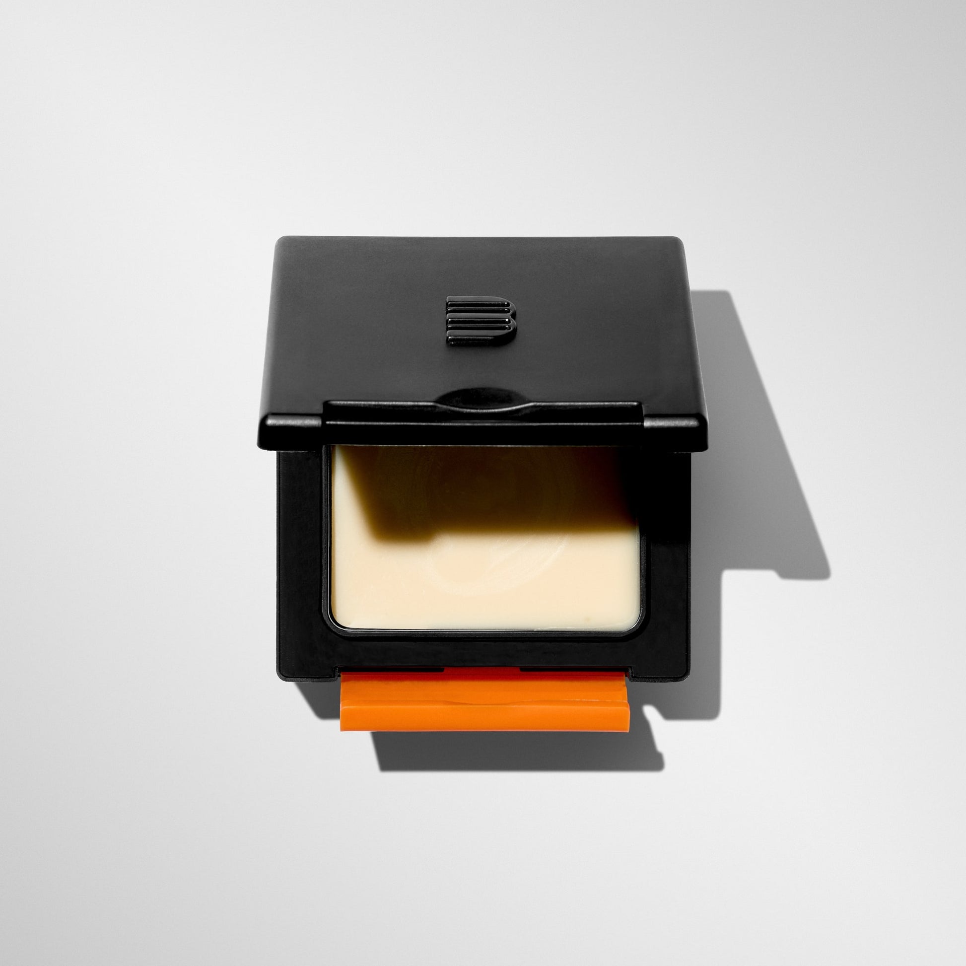 Top view of open BLUMAAN Heavy Hold Clay packaging revealing thick styling clay inside